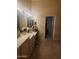 Large bathroom vanity and large mirrors with access to closet and separate bathroom at 7646 E Miami Rd, Scottsdale, AZ 85258