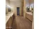 This bathroom features double sinks with large mirrors, providing ample space and lighting at 7646 E Miami Rd, Scottsdale, AZ 85258