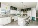Modern kitchen with an island, stainless steel appliances, and white cabinets that offer plenty of storage space at 7646 E Miami Rd, Scottsdale, AZ 85258