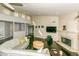 Spacious living room with a fireplace, dark wood floors, and large windows for natural light at 7646 E Miami Rd, Scottsdale, AZ 85258
