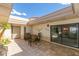 Relaxing patio area with a tile floor, dining table and chairs, and privacy walls at 7646 E Miami Rd, Scottsdale, AZ 85258