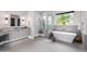 Bright bathroom featuring a soaking tub, and a walk-in shower with elegant light gray cabinetry at 9627 E Adobe Dr, Scottsdale, AZ 85255