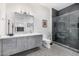 Contemporary bathroom with double vanity, walk-in shower, and stylish patterned tile flooring at 9627 E Adobe Dr, Scottsdale, AZ 85255