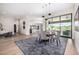 Bright dining room with desert views through large windows next to the modern open kitchen at 9627 E Adobe Dr, Scottsdale, AZ 85255
