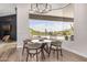 Bright dining area with large windows offering panoramic views of the pool and desert landscape at 9627 E Adobe Dr, Scottsdale, AZ 85255