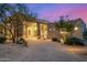 Paver driveway leading to an elegant desert home with lush landscaping, and desert plants at 9627 E Adobe Dr, Scottsdale, AZ 85255