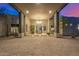 Elegant covered entrance with a modern chandelier and sleek glass front door at 9627 E Adobe Dr, Scottsdale, AZ 85255