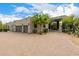 Beautiful home featuring a long driveway, desert landscaping, and a three-car garage at 9627 E Adobe Dr, Scottsdale, AZ 85255