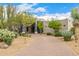 Beautiful home with desert landscaping and a long brick driveway at 9627 E Adobe Dr, Scottsdale, AZ 85255