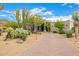 Expansive desert home with a meticulously designed driveway and lush native landscaping at 9627 E Adobe Dr, Scottsdale, AZ 85255