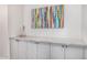 Hallway with stone counter and cabinets below, as well as a colourful picture hanging above at 9627 E Adobe Dr, Scottsdale, AZ 85255