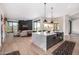 Open-concept kitchen featuring a waterfall island, modern appliances, and seamless flow to the living area at 9627 E Adobe Dr, Scottsdale, AZ 85255