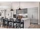 Modern kitchen with sleek gray cabinets, a large island, and modern pendant lighting at 9627 E Adobe Dr, Scottsdale, AZ 85255