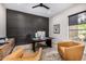 Modern home office featuring a dark paneled wall and lots of natural light at 9627 E Adobe Dr, Scottsdale, AZ 85255