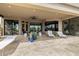This covered patio area features ample seating and natural light perfect for enjoying the outdoors at 9627 E Adobe Dr, Scottsdale, AZ 85255