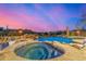 Enjoy a luxurious outdoor pool and spa with waterfall features amidst serene landscaping and a picturesque desert backdrop at 9627 E Adobe Dr, Scottsdale, AZ 85255