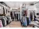 Spacious walk-in closet with custom shelving and organizational systems for clothing and accessories at 9627 E Adobe Dr, Scottsdale, AZ 85255