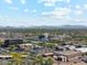 Expansive city view featuring various commercial and residential buildings, a water tower, and distant mountain views at 991 W Leah Ln, Gilbert, AZ 85233