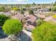 Aerial view of a home with a well-maintained yard, mature trees, and a private pool at 991 W Leah Ln, Gilbert, AZ 85233