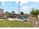 Spacious backyard with a refreshing pool, gazebo, built-in grill, and lush green lawn at 991 W Leah Ln, Gilbert, AZ 85233