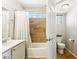 Bright bathroom featuring a single sink vanity and a tub with tiled wall at 991 W Leah Ln, Gilbert, AZ 85233