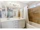 Well-lit bathroom featuring double sinks and a shower-tub combo at 991 W Leah Ln, Gilbert, AZ 85233