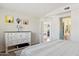 Well-lit bedroom showcasing a dresser and closet entrance at 991 W Leah Ln, Gilbert, AZ 85233