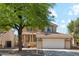 Charming two-story home featuring a well-maintained front yard, covered entryway, and attached two-car garage at 991 W Leah Ln, Gilbert, AZ 85233