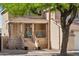 Inviting front porch with neutral stone accents, charming railings, steps, and ample seating, under the shade of mature tree at 991 W Leah Ln, Gilbert, AZ 85233