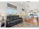 Spacious living area boasts an abundance of natural light, wood flooring, and an open floor plan to the kitchen at 991 W Leah Ln, Gilbert, AZ 85233