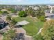 Aerial view of a community park featuring a basketball court, walking paths, and lush greenery at 991 W Leah Ln, Gilbert, AZ 85233