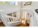 Bright staircase with hardwood steps and white railings offering access to the upper level at 991 W Leah Ln, Gilbert, AZ 85233