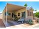 Inviting manufactured home with a covered carport and a charming patio area at 111 S Greenfield Rd # 611, Mesa, AZ 85206