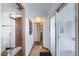 Hallway featuring access to a full bathroom with glass shower and a sliding glass door to the outside at 111 S Greenfield Rd # 611, Mesa, AZ 85206