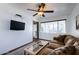 Inviting living room featuring a ceiling fan, comfortable sofa, and large windows offering plenty of natural light at 111 S Greenfield Rd # 611, Mesa, AZ 85206