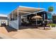 Beautiful RV parking area with an awning, outdoor seating, privacy fence, and manicured landscaping at 111 S Greenfield Rd # 784, Mesa, AZ 85206