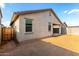 A fenced backyard and exterior of the house at 11505 W Boca Raton Rd, El Mirage, AZ 85335