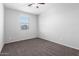 A cozy bedroom featuring neutral walls, carpet flooring, and a ceiling fan at 11505 W Boca Raton Rd, El Mirage, AZ 85335
