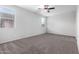Spacious carpeted bedroom features a ceiling fan and natural light at 11505 W Boca Raton Rd, El Mirage, AZ 85335