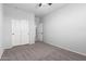 A bedroom with neutral walls, carpet, and a double-door closet at 11505 W Boca Raton Rd, El Mirage, AZ 85335