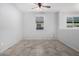Cozy bedroom featuring tile flooring, neutral paint, and abundant natural light at 11505 W Boca Raton Rd, El Mirage, AZ 85335
