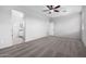 Spacious carpeted bedroom with ceiling fan and ensuite bathroom at 11505 W Boca Raton Rd, El Mirage, AZ 85335