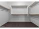 Walk-in closet with wood shelving and carpet at 11505 W Boca Raton Rd, El Mirage, AZ 85335