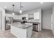 Bright kitchen features granite counters, stainless steel appliances and an island with stainless steel fridge at 11505 W Boca Raton Rd, El Mirage, AZ 85335
