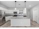 Bright kitchen features granite counters, stainless steel appliances and an island with pendant lighting at 11505 W Boca Raton Rd, El Mirage, AZ 85335