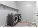 A laundry room featuring a tiled floor, shelving, washer and dryer hookups at 11505 W Boca Raton Rd, El Mirage, AZ 85335