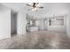Open-concept living room featuring tile flooring, a ceiling fan, and seamless flow to the kitchen at 11505 W Boca Raton Rd, El Mirage, AZ 85335
