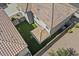 Aerial view of the private backyard with artificial turf, covered patio, and plenty of space for entertaining at 1317 N Balboa --, Mesa, AZ 85205