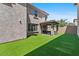 Backyard featuring green artificial turf, a covered patio, and privacy fencing at 1317 N Balboa --, Mesa, AZ 85205
