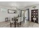 Bright dining area with wood-look tile floors, seating for six, and a view of the outdoor patio at 1317 N Balboa --, Mesa, AZ 85205